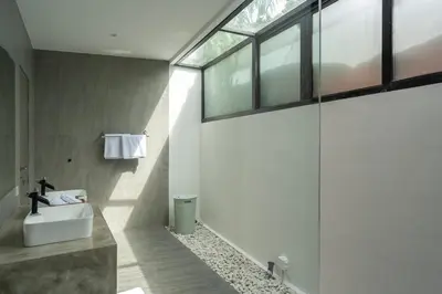 a bathroom with a sink and a large window at LOTUS - Bali Invest Club in Kerobokan