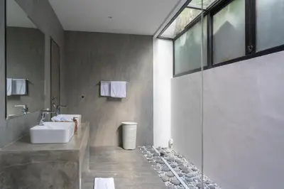 a bathroom with a sink and a glass wall at LOTUS - Bali Invest Club in Kerobokan