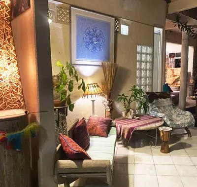 a living room with a couch and a table at Shady Grove Healing Centre & Homestay w house rules please read before booking in Sanur