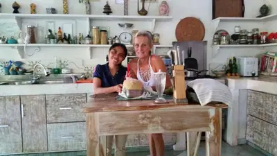two women standing at a table in a kitchen at Shady Grove Healing Centre & Homestay w house rules please read before booking in Sanur