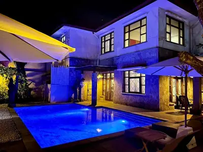 a house with a swimming pool at night at kuta 5BR private villa pool ,near airport, in Kuta