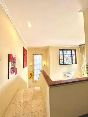 a hallway with a staircase in a home with a window at kuta 5BR private villa pool ,near airport, in Kuta