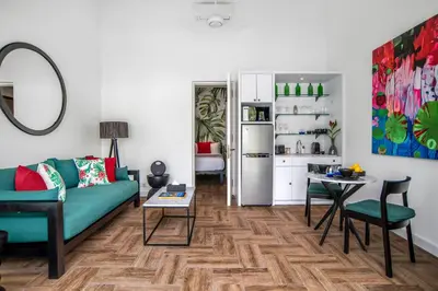 a living room with a couch and a table and a refrigerator at Villa Balik II Seminyak in Seminyak