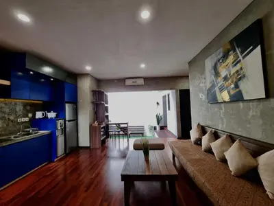 a living room with a couch and a table at Bali 3BR Family Nicho House in Seminyak