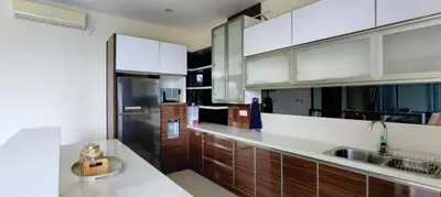 a kitchen with white cabinets and a stainless steel refrigerator at Casa de Prospera - 3BR Villa with Private Pool in Nusa Dua