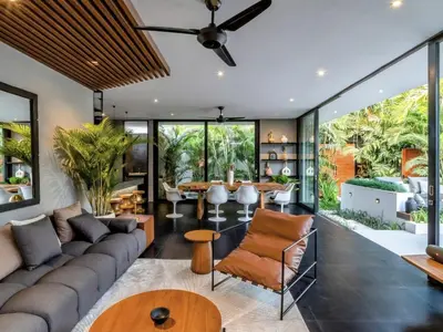 a living room with a couch and a table at Villa Naura Umalas in Dalung