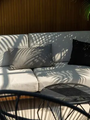 a couch with pillows sitting on top of a table at Villa Naura Umalas in Dalung