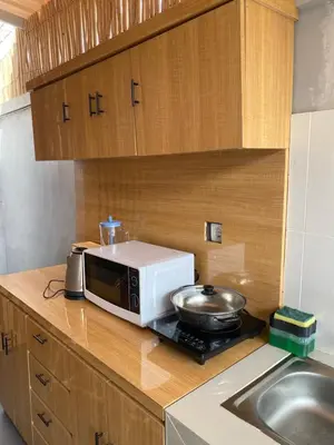 a microwave sitting on top of a kitchen counter at Queen’s Villa in Seminyak