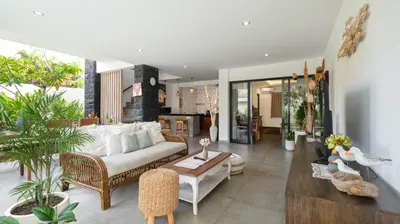 a living room with a couch and a table at Villa Ambalika by Villa Finder in Seminyak