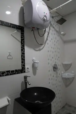 a bathroom with a black sink and a security camera at Doris Seminyak Studio in Seminyak