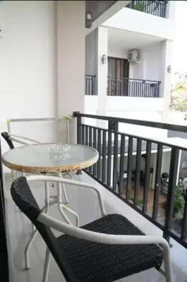 a table and a chair on a balcony at Doris Seminyak Studio in Seminyak