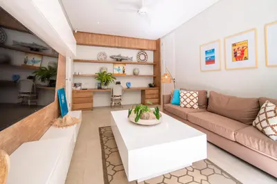 a living room with a couch and a table at Villa Sunsara 4 - Enchanting 4BR Villa in a Great Location in Canggu