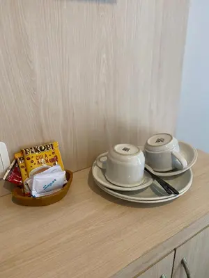 a table with two cups and plates on it at Queens Villa in Seminyak