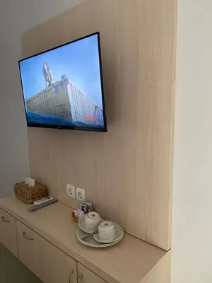 a flat screen tv hanging on a wall at Queens Villa in Seminyak