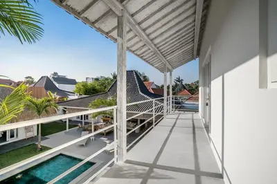a view from the balcony of a house with a swimming pool at Villa Surga Julie by Alfred in Bali in Seminyak