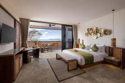 a hotel room with a bed and a balcony at Sumitra Luxury Villas & Resort by Pramana in Sanur