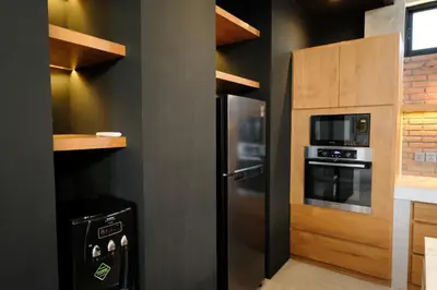 a kitchen with a stainless steel refrigerator and a microwave at Manresa Villa Bali 3 in Canggu