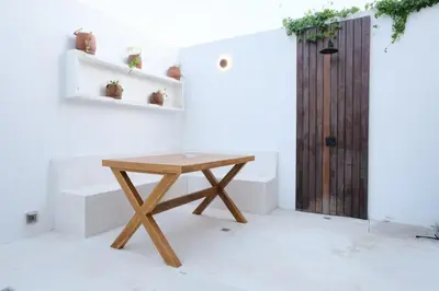 a wooden table in a room with a door at Manresa Villa Bali 3 in Canggu