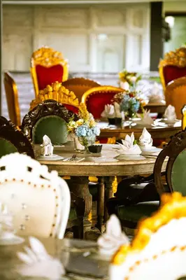 a long table with chairs and flowers on it at Morabito Art Villa in Canggu