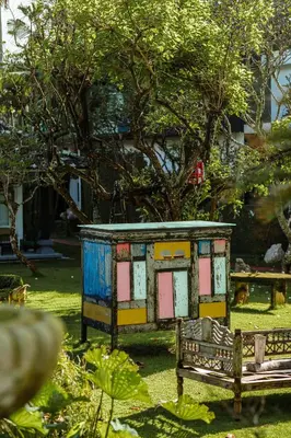 a smallshed sitting next to a bench in a park at Morabito Art Villa in Canggu