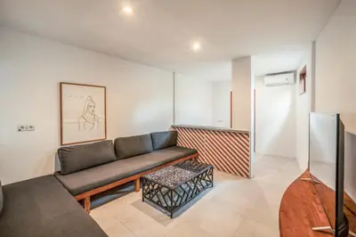 a living room with a couch and a table at Batu Belig Living by CPM Bali in Seminyak
