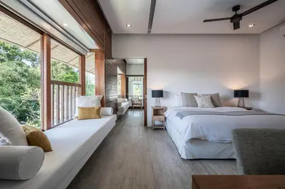 a bedroom with two beds and a large window at Villa Batu Sari in Canggu