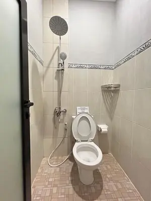 a bathroom with a shower with a toilet at Pondok Puspa Sumekar in Seminyak
