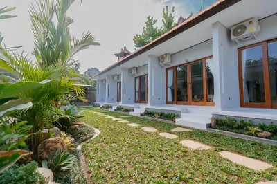a house with a garden in front of it at Pondok Puspa Sumekar in Seminyak