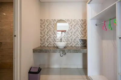a bathroom with a sink and a mirror at RedDoorz Plus at Yasa's Living Denpasar in Sanur