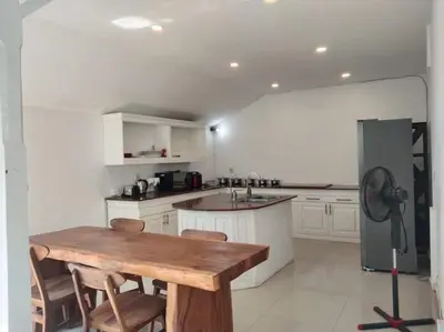a kitchen with a wooden table and a refrigerator at 2BR private villa in Seminyak, Ayu Putri in Seminyak