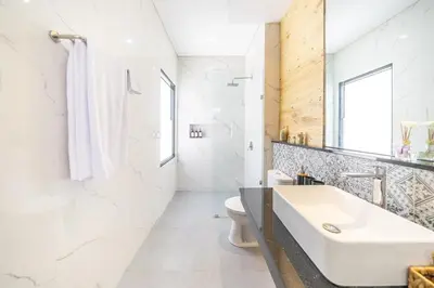 a white bathroom with a sink and a toilet at New Modern Villa in Bali in Legian