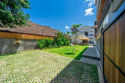 a courtyard of a building with a grass yard at New Modern Villa in Bali in Legian