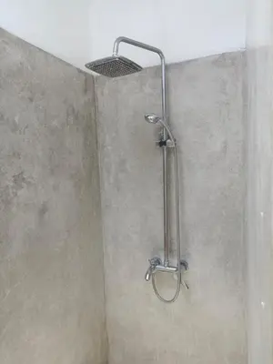 a shower with a shower head in a bathroom at Villa Lumbung Krobokan in Seminyak
