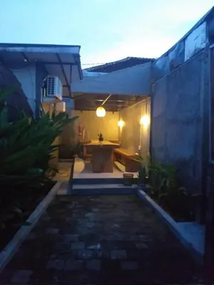 a patio with a table in the middle of a building at Villa Lumbung Krobokan in Seminyak