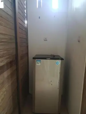 a small white refrigerator in a room at Villa Lumbung Krobokan in Seminyak