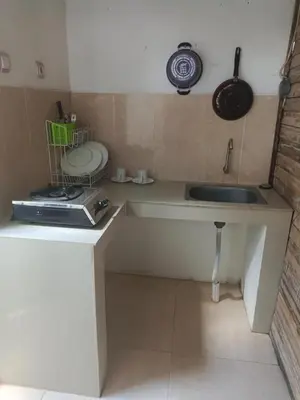 a small kitchen with a sink and a toilet at Villa Lumbung Krobokan in Seminyak
