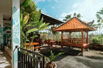 a gazebo with chairs and tables in a patio at Umah Kita Villa in Seminyak