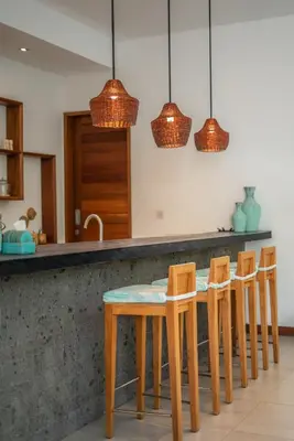 a kitchen with a table and four chairs at Villa Cuatro : Amazing 3BR Villa in Seminyak - Perfect Location in Seminyak