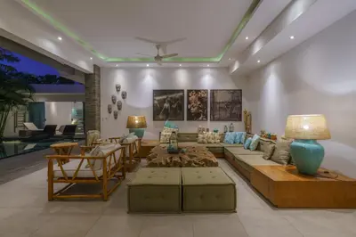 a living room with a couch and a table at Villa Cuatro : Amazing 3BR Villa in Seminyak - Perfect Location in Seminyak