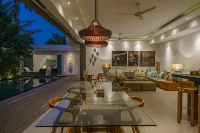 a living room with a table and a couch at Villa Cuatro : Amazing 3BR Villa in Seminyak - Perfect Location in Seminyak