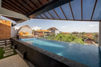 a swimming pool with a view of the water at Mokko Suites Batubelig in Canggu