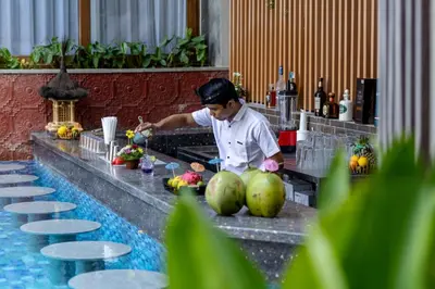 a chef preparing food at a buffet in a restaurant at Mokko Suites Batubelig in Canggu