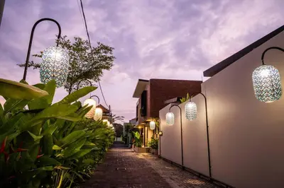 a street with lights on the side of a building at Villa Akhila 2 - 2 BR modern tropical villa at the heart of Seminyak in Seminyak