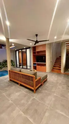 a living room with a couch and a ceiling fan at Akhila 3 - 2 BR Modern tropical villa at the heart of Seminyak in Seminyak
