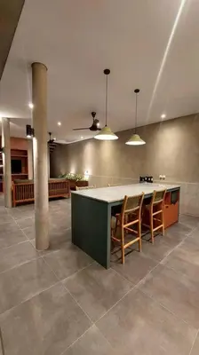 a kitchen with a table and chairs in a room at Akhila 3 - 2 BR Modern tropical villa at the heart of Seminyak in Seminyak