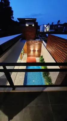 a view of a balcony with two chairs and a pool at Akhila 3 - 2 BR Modern tropical villa at the heart of Seminyak in Seminyak