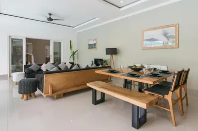 a living room with a couch and a table at Modern villa near Atlas beach club & beach in Canggu