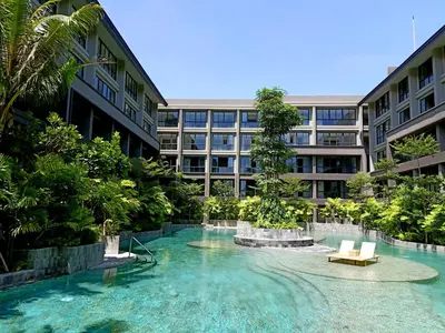 a building with a fountain in the middle of a courtyard at Anagata Hotels and Resorts Tanjung Benoa in Nusa Dua