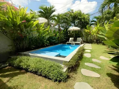 a swimming pool in the middle of a yard at Incredible villa near Atlas beach club Berawa in Canggu