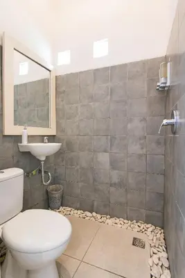 a bathroom with a toilet and a sink at Incredible villa near Atlas beach club Berawa in Canggu